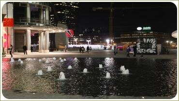 Маленькие бьющие фонтанчики на ночной площади