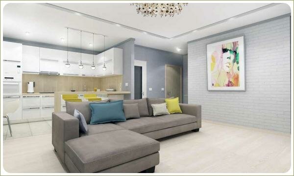 Современная гостиная и камень Гостиная студия в серых тонах с отделкой стены из белого камня и серая мебель на фоне кухни