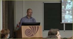 Мужчина за кафедрой делает доклад 